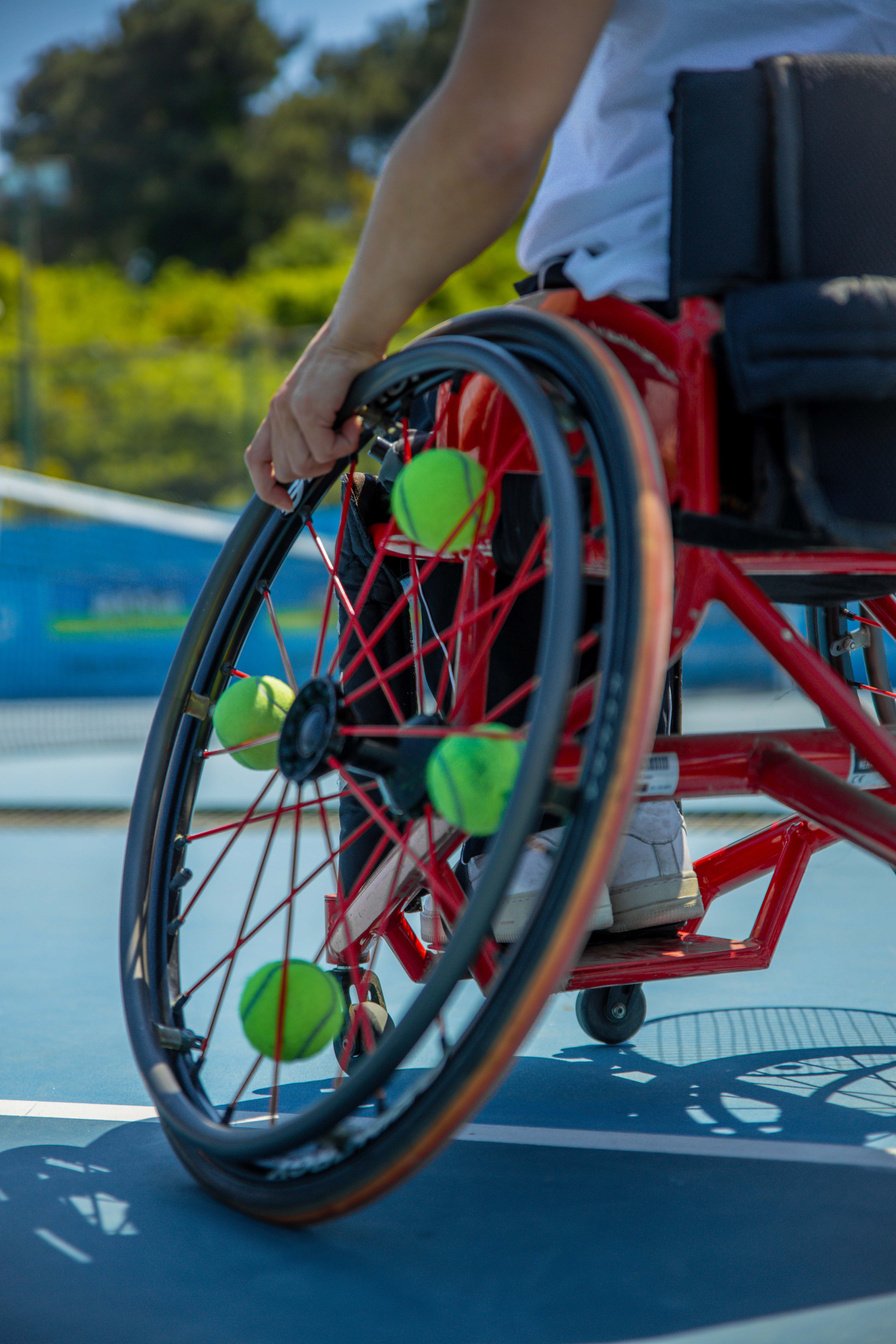 Tennis Balls on a Wheelchair of a Person with Disability