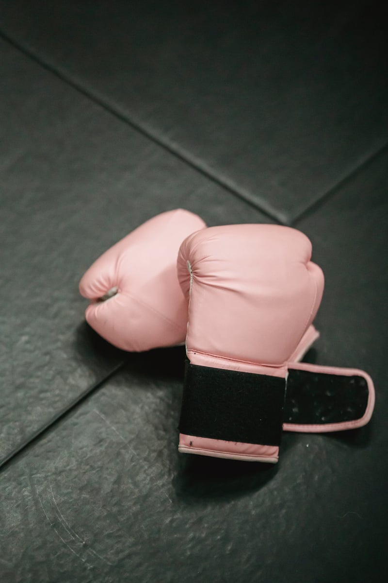 Boxing gloves on sports mat in gym